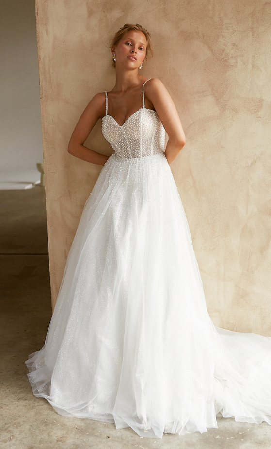 The voluminous skirt features layers of sparkle and plain tulle