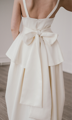 The Lila Peplum cinches the waist and can be tied at either the front or back