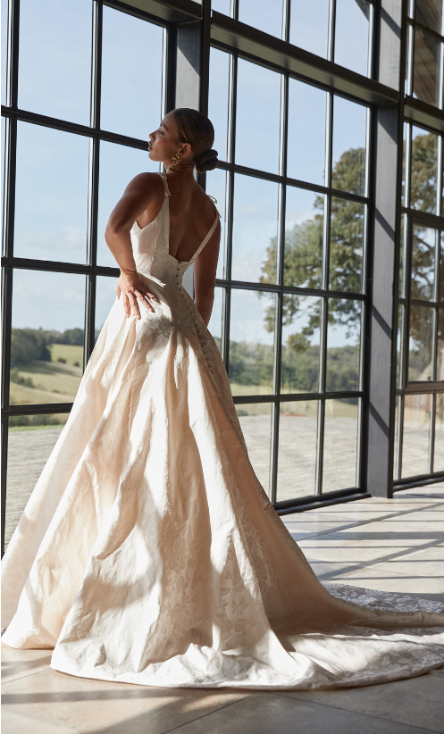 The dress is finished with a dramatic deep square neck and back