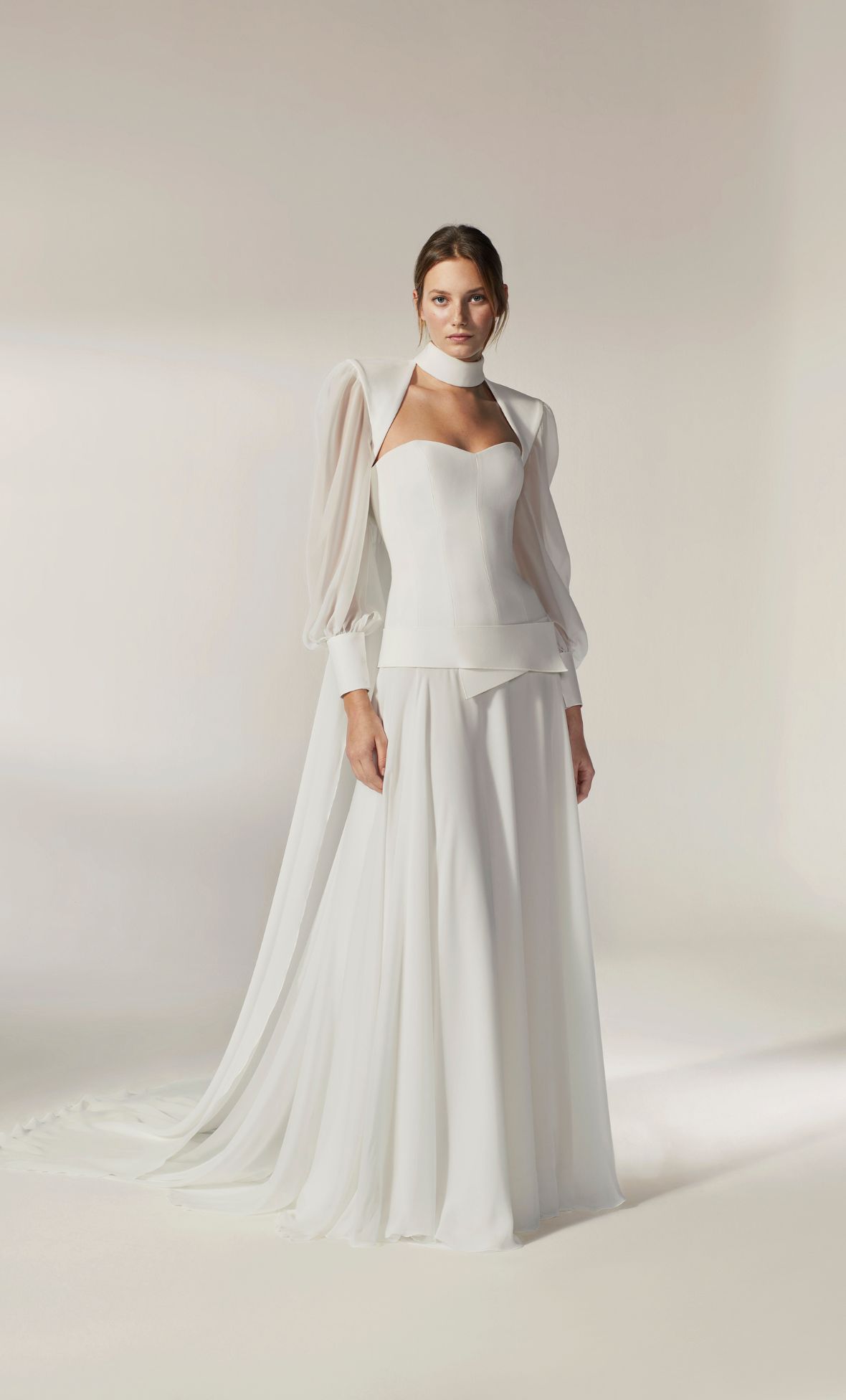 This style hits all the trend high notes: low waist corset, flowing skirt and tailored cape 