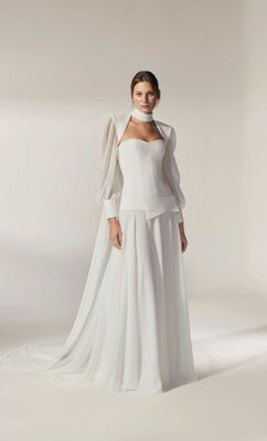 This style hits all the trend high notes: low waist corset, flowing skirt and tailored cape 
