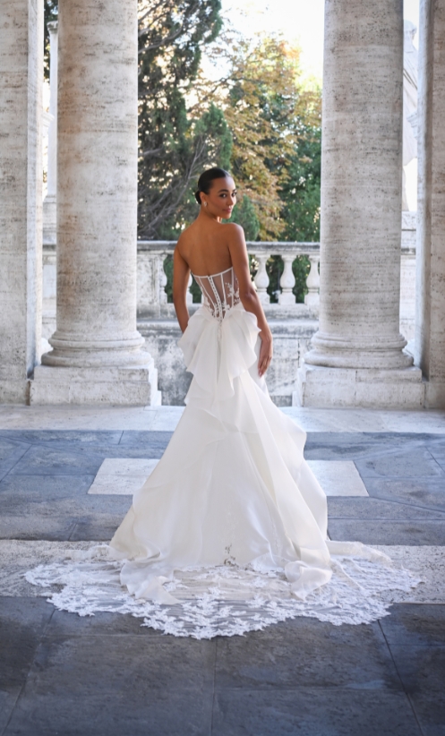 Limoncello has an illusion back and dramatic lace appliqué glass train